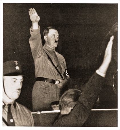 Adolf Hitler salutes his followers at a Nazi Party rally soon after his appointment as Chancellor. (February 1933).